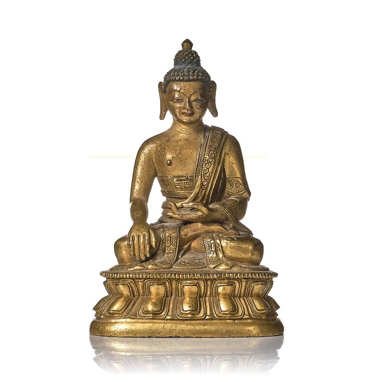 A gilt bronze figure of Shakyamuni buddha, Tibeto-Chinese, 18th century.