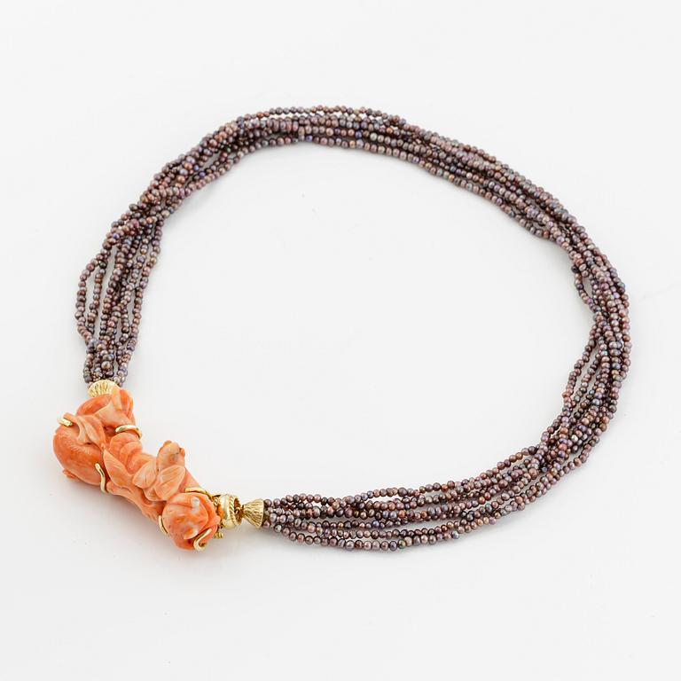 Multi-strand pearl necklace with two clasps set with carved coral, cabochon-cut tourmaline, and brilliant-cut diamonds.