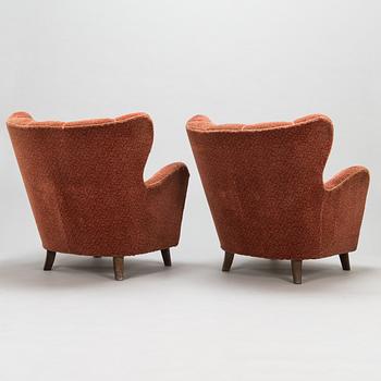 A pair of mid 20th Century armchairs.