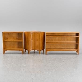 A three piece corner book case with a cabinet.