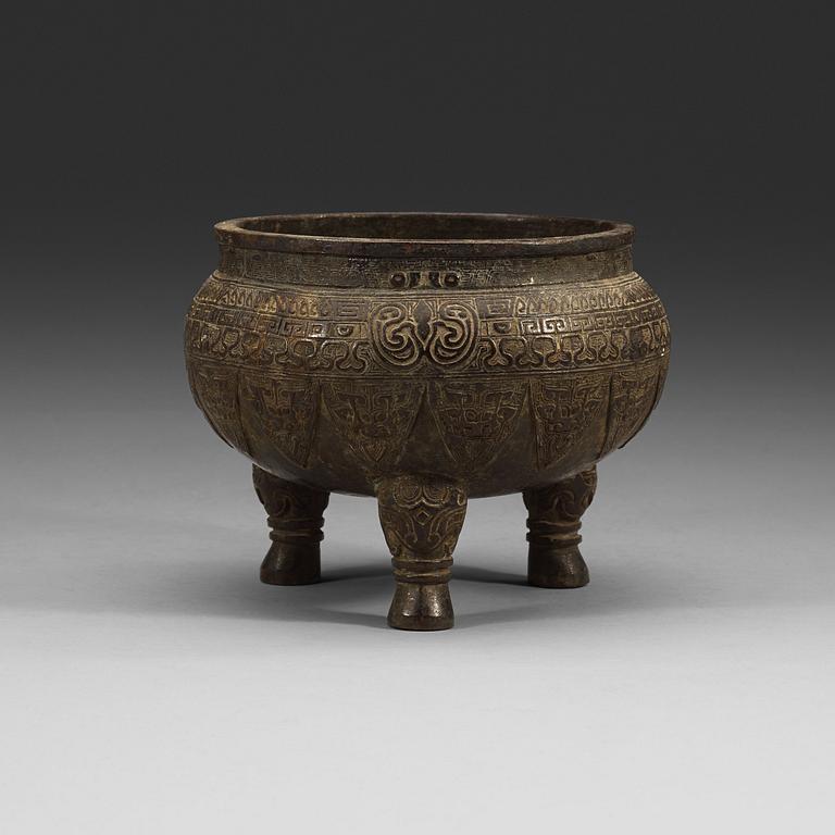 A bronze tripod censer, presumably Ming dynasty.