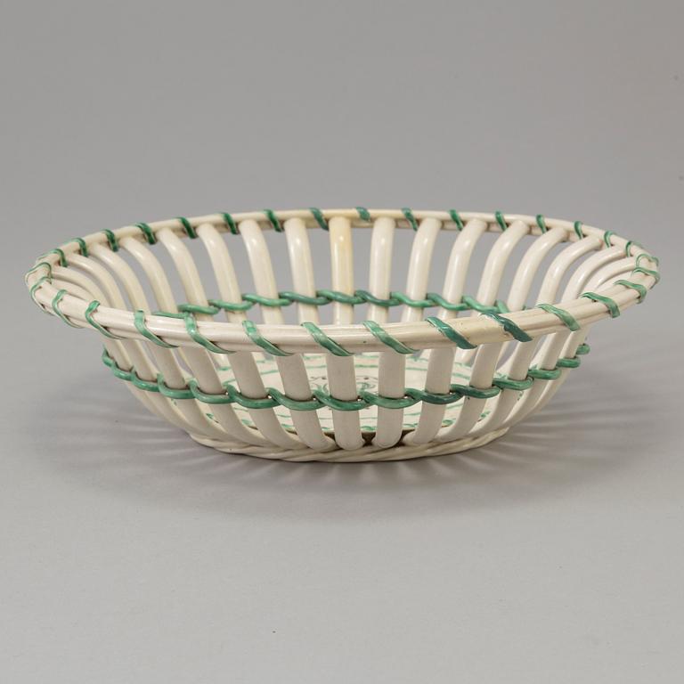 A CREAMWARE BASKET, PLATE AND A SIMILAR PLATE, one marked Wedgwood, first half of the 19th century.