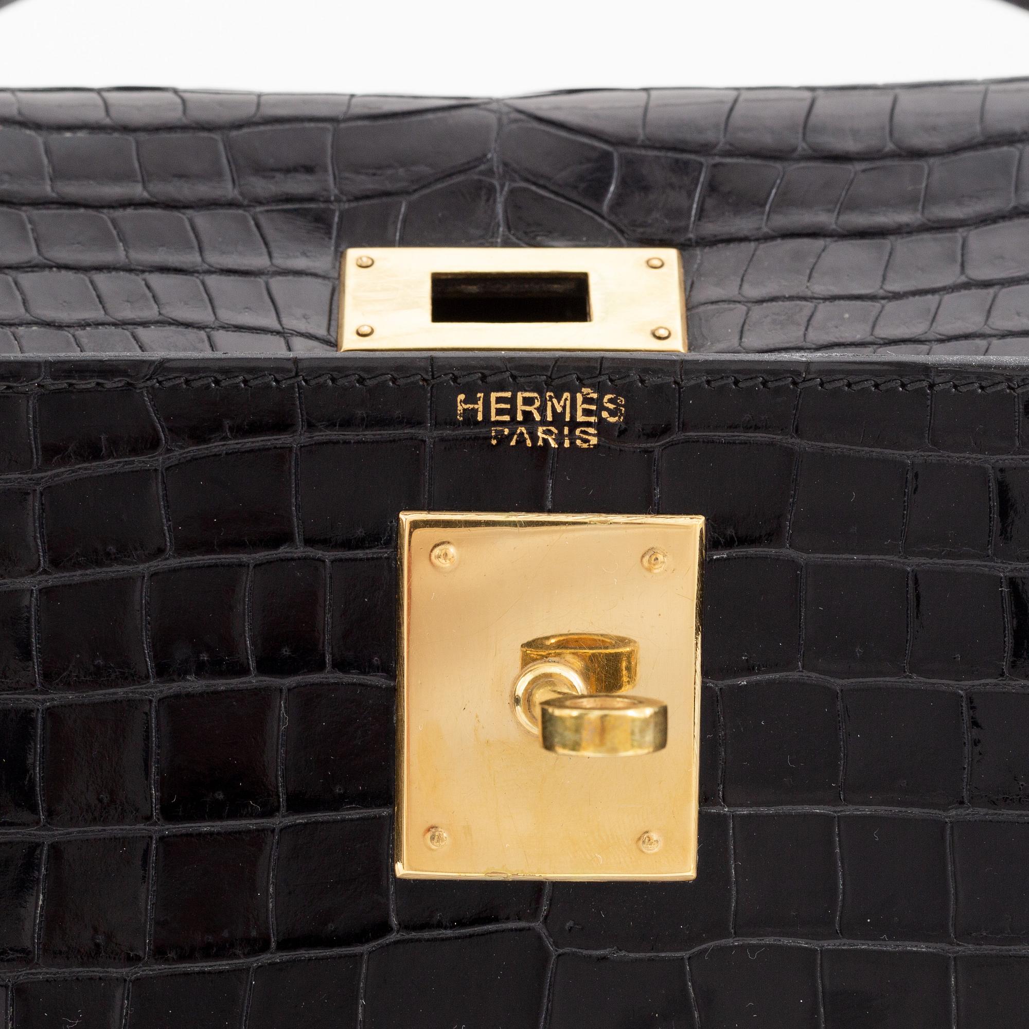1962 black alligator 'Kelly' handbag by Hermès.