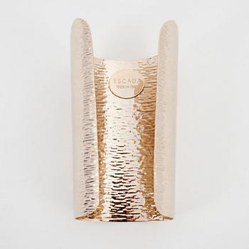 ESCADA, a golden metal bracelet.