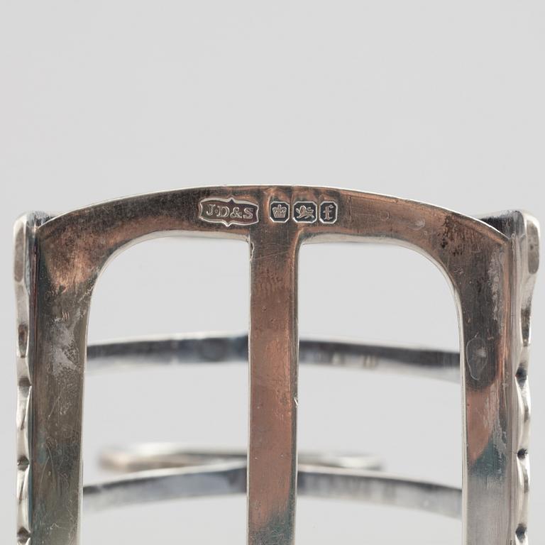 A set of four English silver salt cellars and a toast rack, including Roberts & Belk, Sheffield, England 1898.