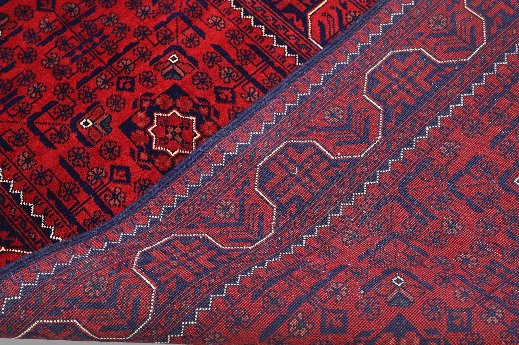 A Afghan runner carpet, 304 x 84 cm.