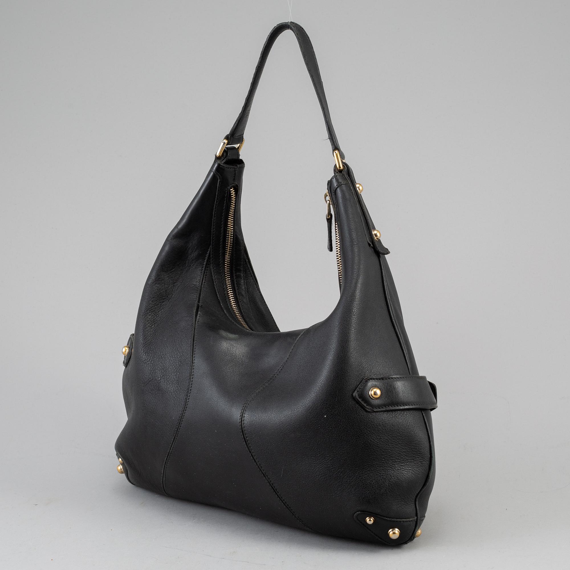 GUCCI, a leather horse-bit bag.