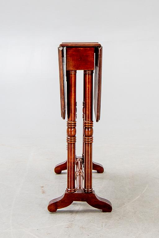 A 20th century English mahogany folding table.