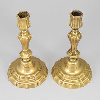 A pair of 18th century bronze candlesticks.