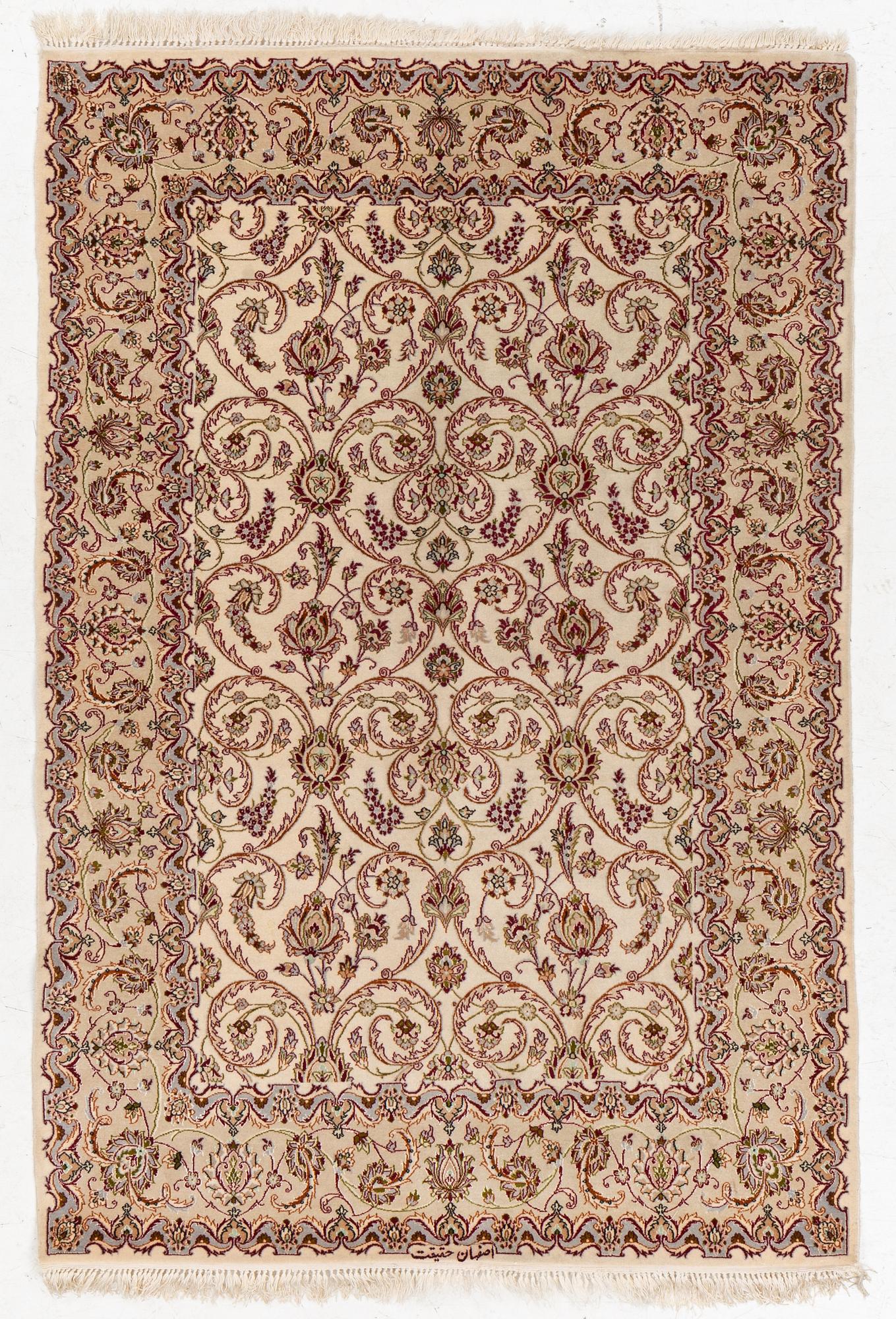 An Isfahan, part silk rug, signed, c. 165 x 112 cm.