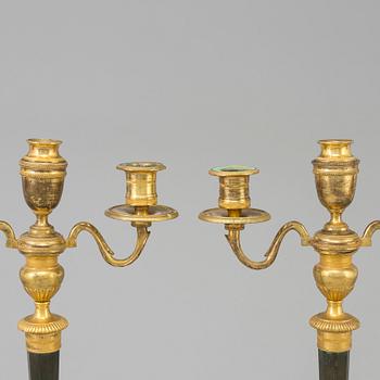 A pair of French Directoire late 18th century ormolu candelabra for three candles.