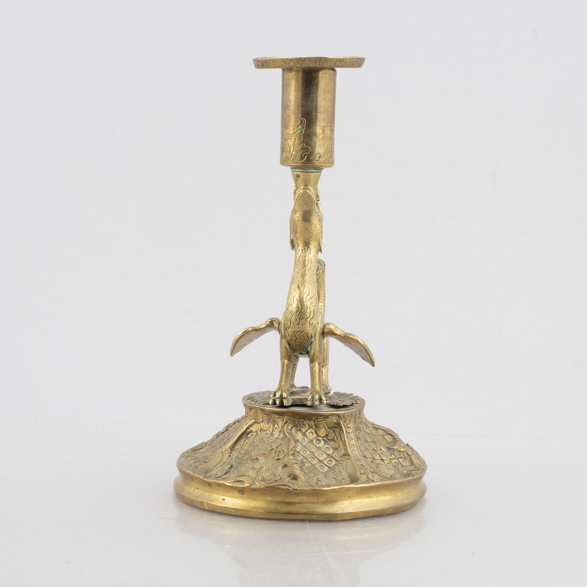 A rococo-style brass candlestick, 18th century and later.