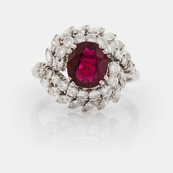 974. A platinum ring set with a faceted ruby and round brilliant- and navette-cut diamonds.