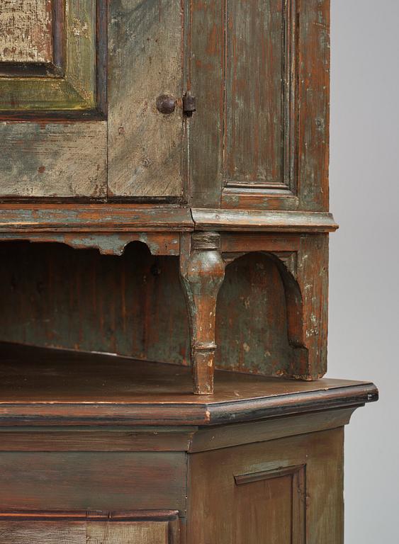A Swedish polychrome-painted corner cabinet attributed to J. Bäckström (1773-1837).