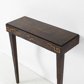 A Swedish Grace mirror and a console table, 1920's/30's.