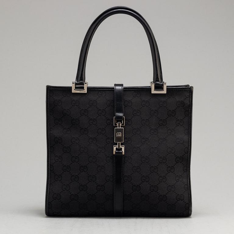 GUCCI, a leather and canvas bag.