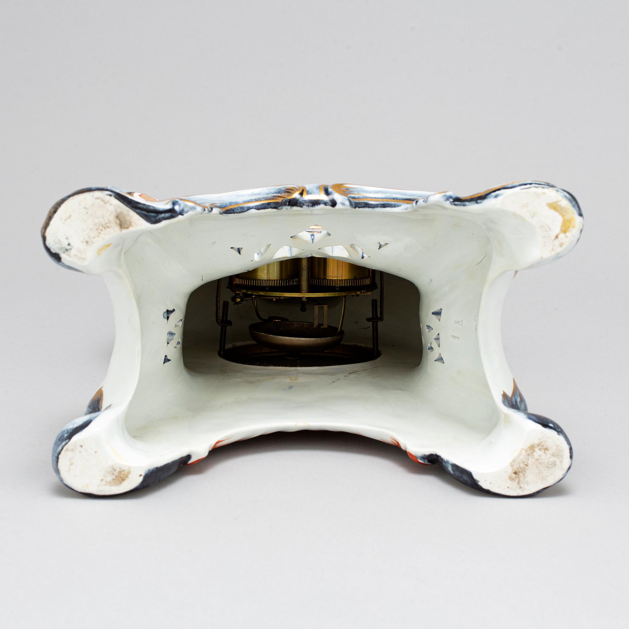 A new rococo creamware bracket clock, after Meissen model, early 20th century.