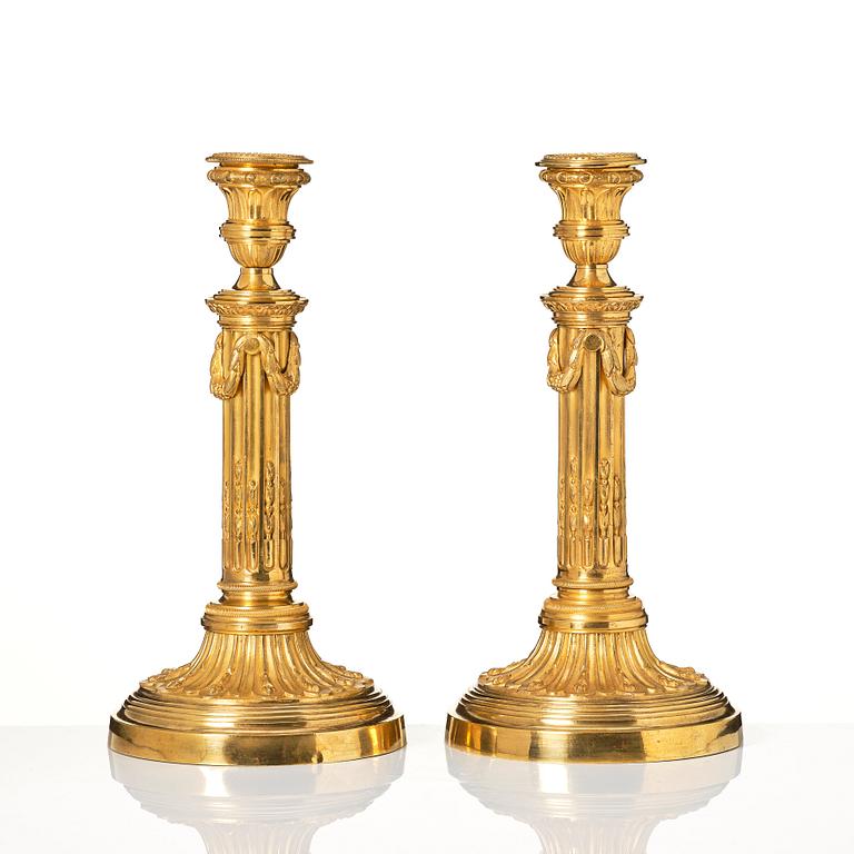 A pair of Louis XVI candlesticks in the manner of Jean Louis Prieurs.