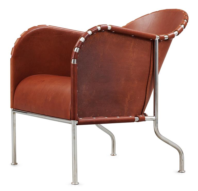 A Mats Theselius steel and brown leather easy chair.