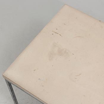 A modern sofa table with concrete top and steel legs.