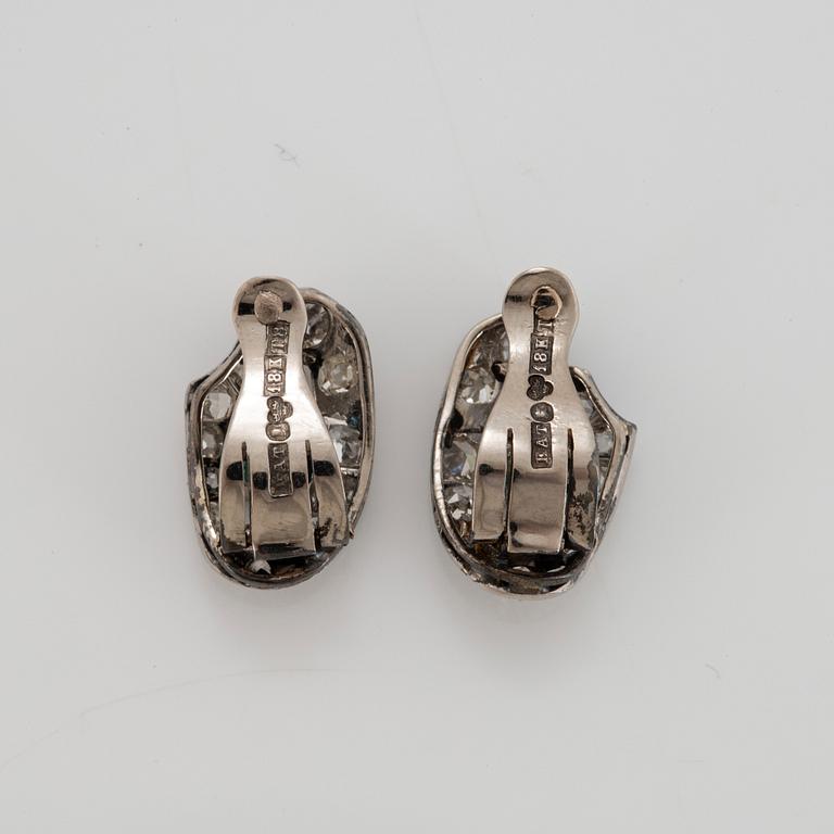 A pair of 18K white gold earrings set with faceted emeralds and old- and eight-cut diamonds.