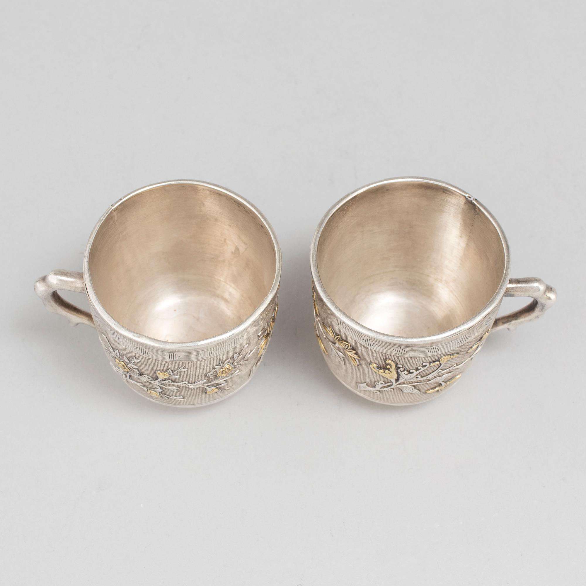 A pair of Chinese silver coffee cups with liners, early 20th Century.