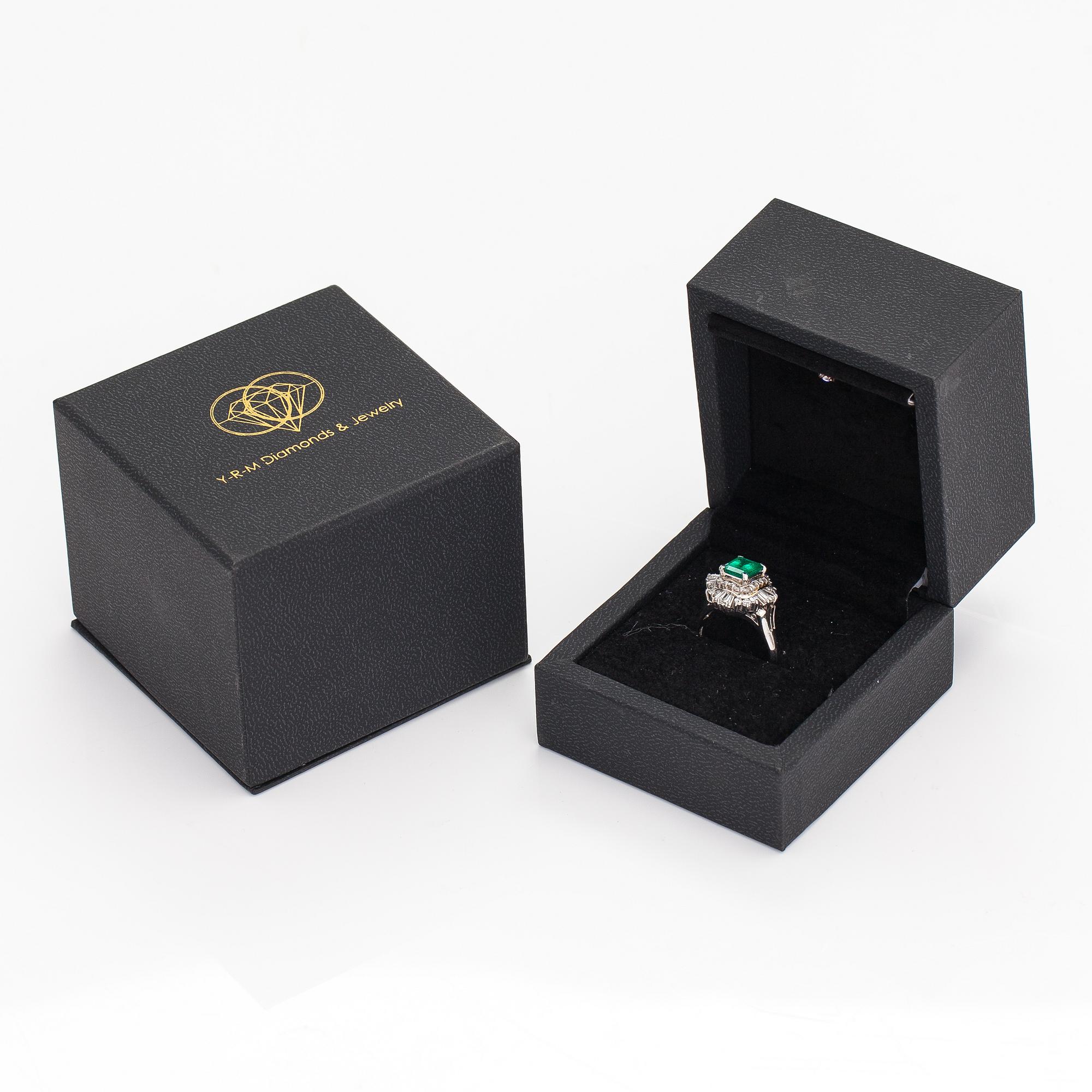 A platinum ring with a ca. 1.15 ct emerald and ca. 1.00 cts of diamonds in total.