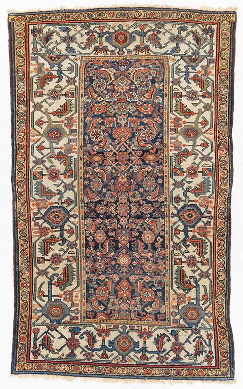 A semi-antique/antique oriental rug, c. 210 x 123 cm.