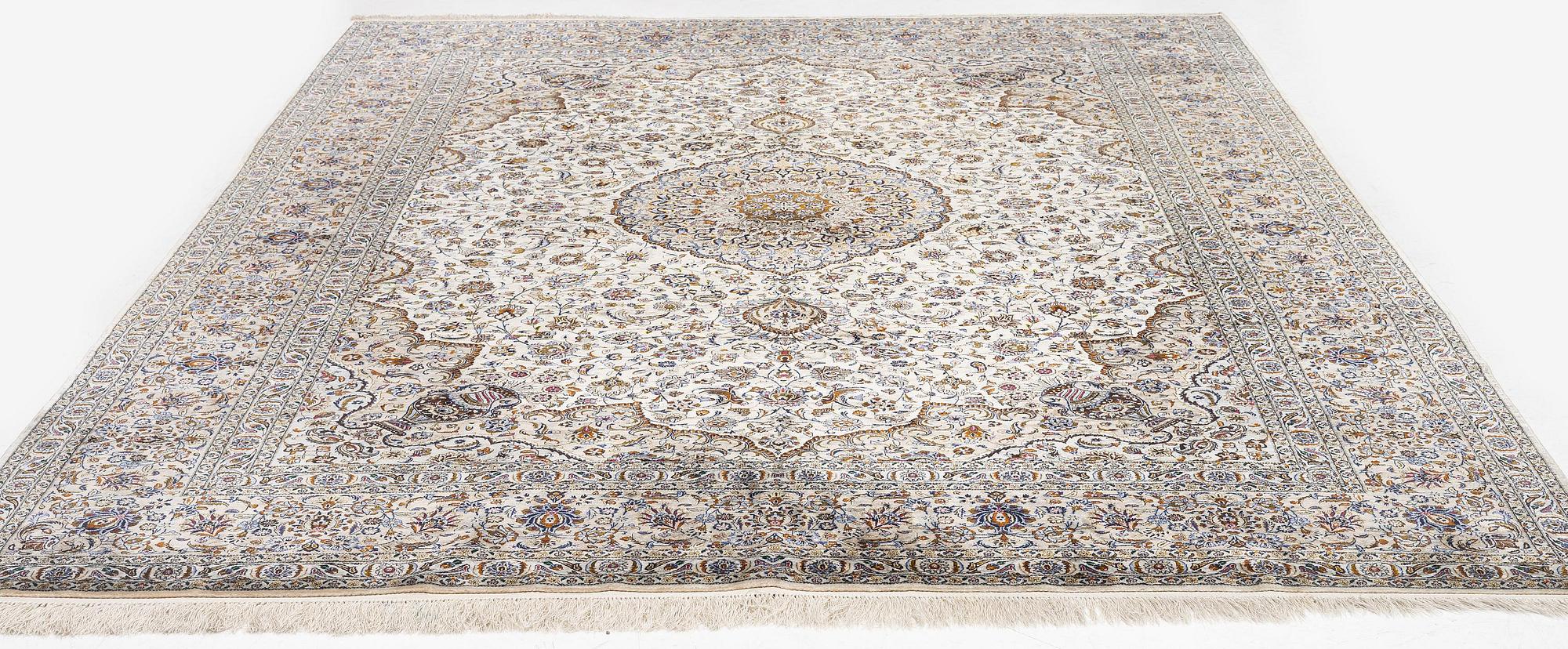 A semi-antique silk Keshan carpet, c. 350 x 248 cm.