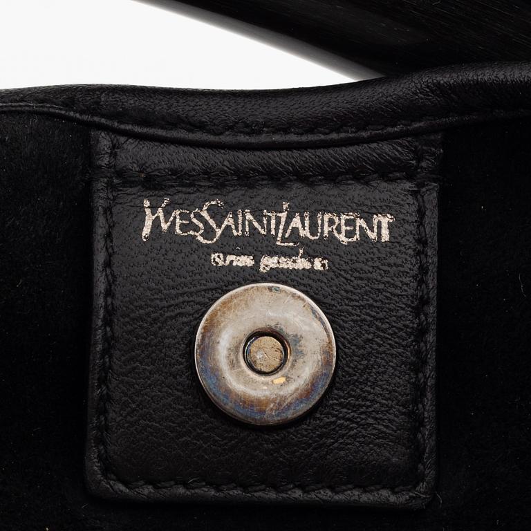 Yves Saint Laurent, a black leather and horn hobo bag.