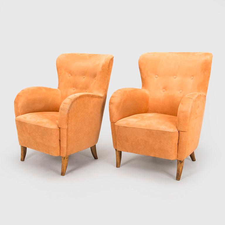 A pair of mid-20th century armchairs.