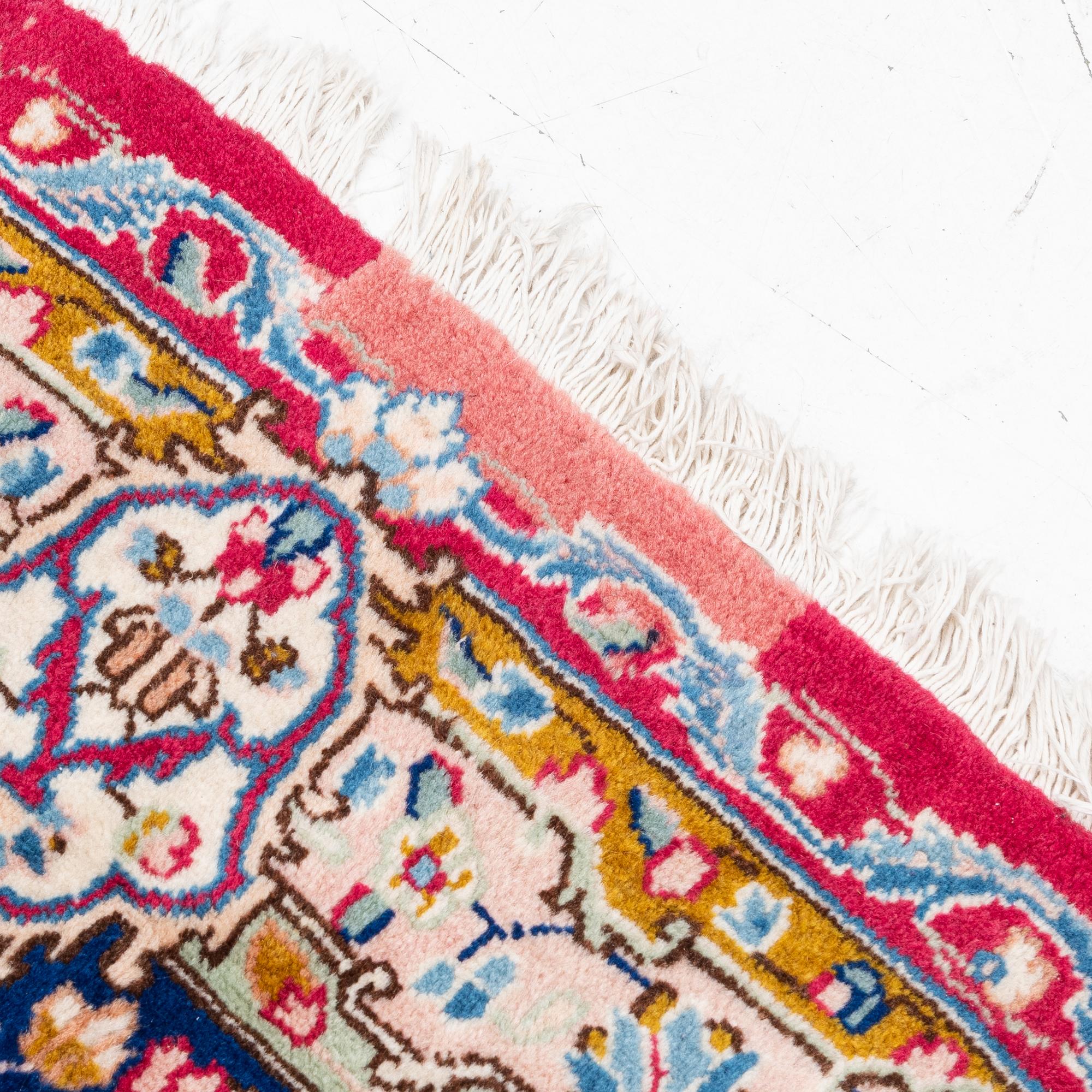A Kirman carpet, signed, c. 388 x 279 cm.