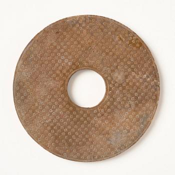 A stone bi disc, Han dynasty (206 B.C.-220 A.D.).