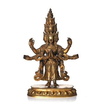 1057. A Tibeto-Chinese gilt bronze figure of Avalokiteshvara Ekasdashamukra, 19th century.