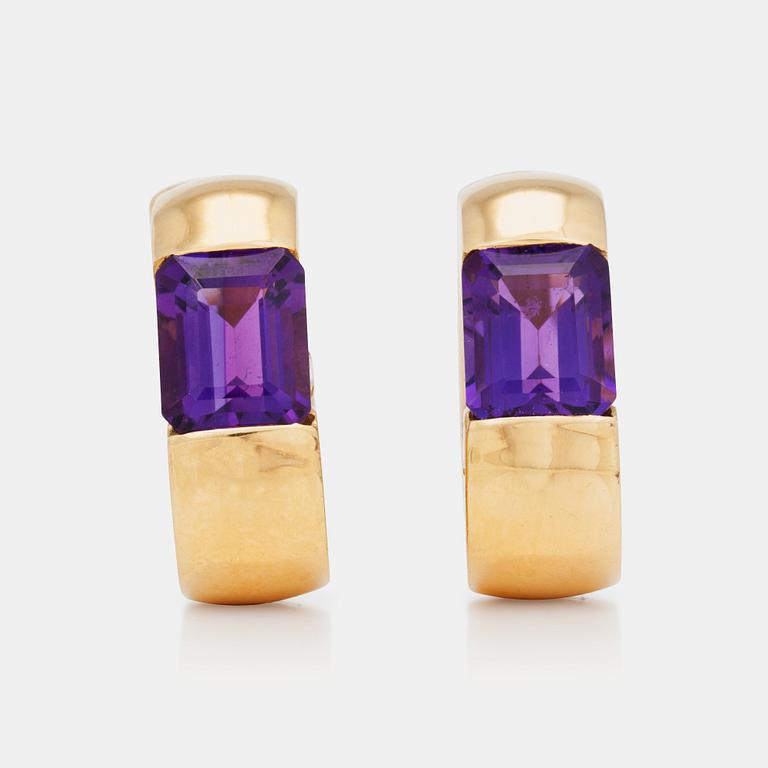 A pair of gold and amethyst earrings.