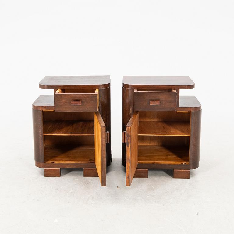 A pair of stained wood bedside tables from the first half of the 20th century.