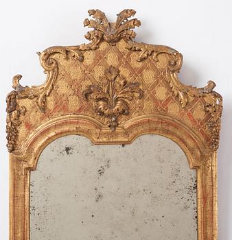 A Northern-European late baroque giltwood mirror, first part of the 18th century.