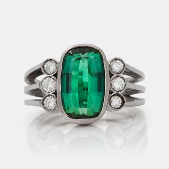 522. A circa 4.00 ct green tourmaline and brilliant-cut diamond ring. Total carat weight of diamonds circa 0.30 ct.