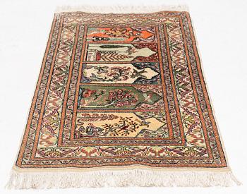 A Kayseri silk rug, c. 110 x 63 cm.