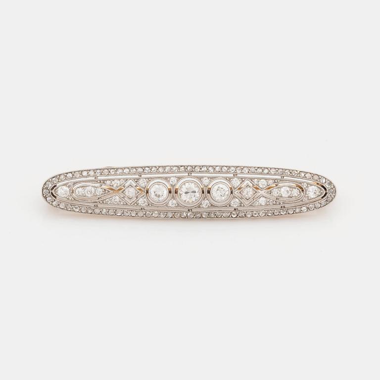 A platinum and 18K gold brooch set with old- and rose-cut diamonds.