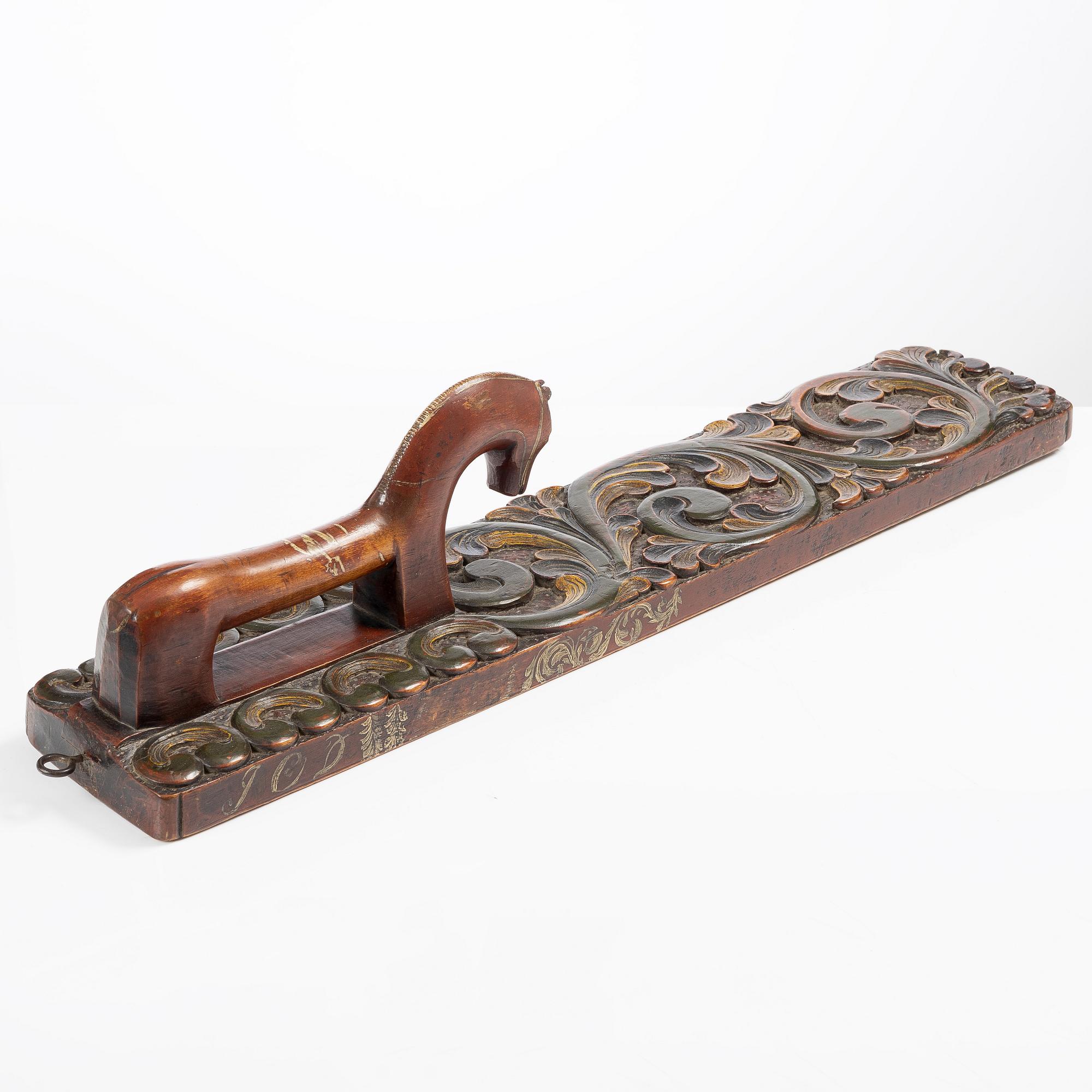 A carved and polychrome painted mangle board, Sweden, late 18th / early 19th century.