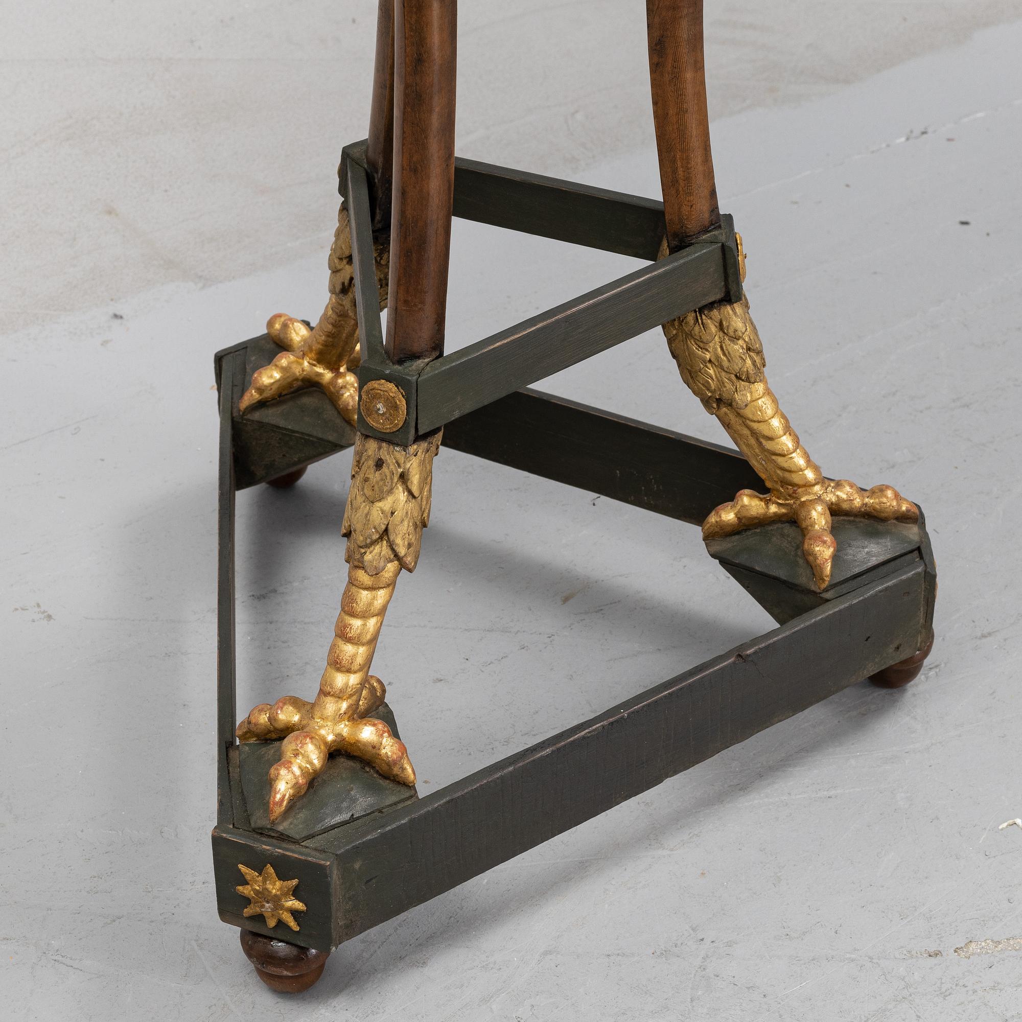 A presumably Russian giltwood and walnut Empire table, early 19th Century.