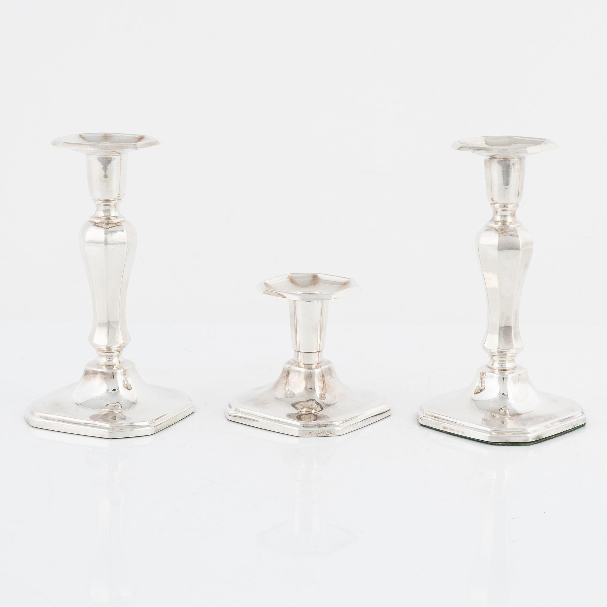 A pair of silver candlesticks, MGAB, Uppsala, 1985 and a silver candlestick, MEMA, Lidköping, 1987.