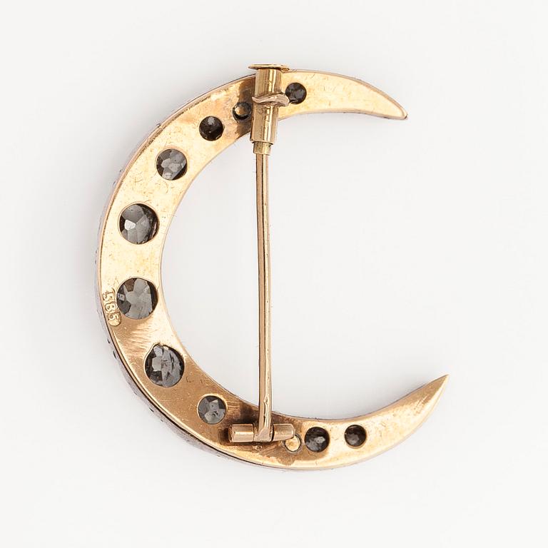 A late 19th century crescent brooch, 14K gold/silver, with old-cut diamonds totalling approximately 1.24 ct.