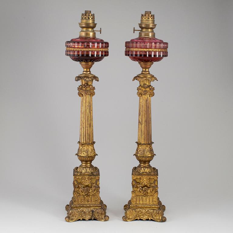 A pair of empire style table oil lamps, bronzed metal and glass, Dublot Freres, Rennes, late 19th century.