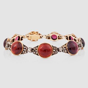 1226. A cabochon-cut garnet and rose-cut diamond bracelet.