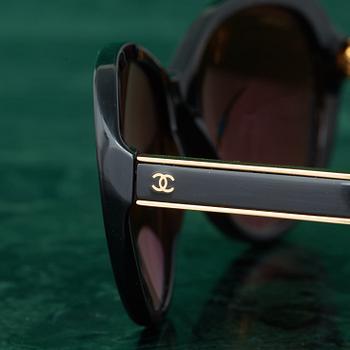 A pair of SUNGLASSES by CHANEL.