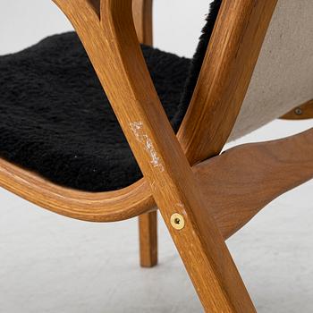 Yngve Ekström, a 'Lamino' armchair and sidetable, Swedese, Sweden, early 21st century.