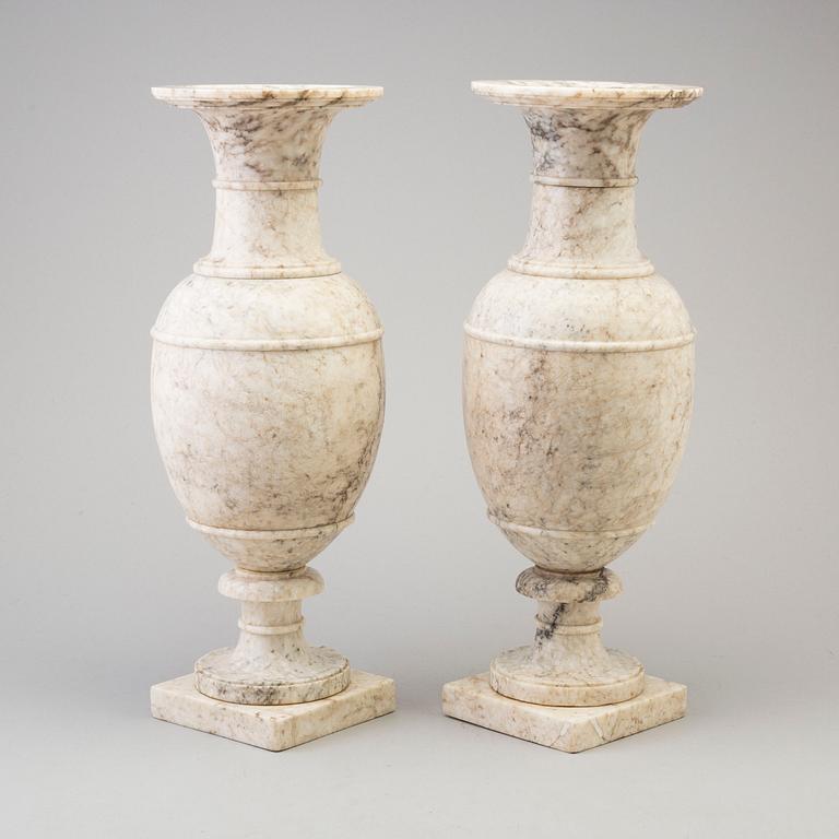 A pair of marble urns, circa 1900.