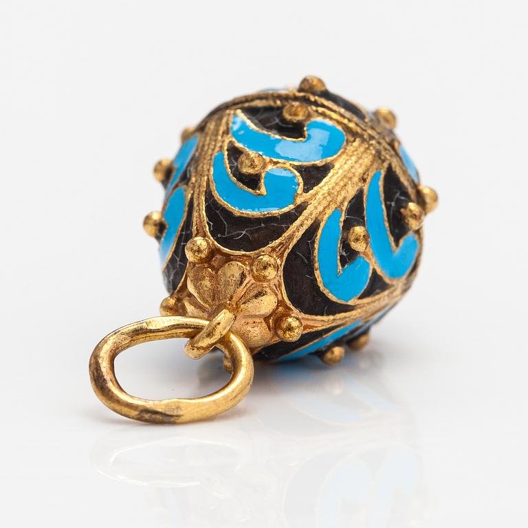 A gilded brass pendant with enamel and glass stones.